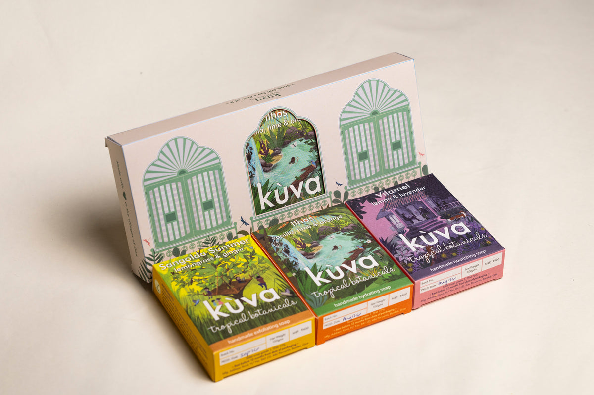 Four Kuva tropical soap boxes arranged in front of a larger matching display box on a clean off-white background. The boxes feature colorful tropical illustrations and labels for different soap flavors: yellow, green, orange, and purple.