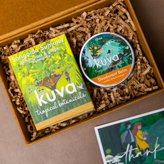 Gift box containing lemongrass soap and natural deodorant balm, with decorative filler and a thank you card.